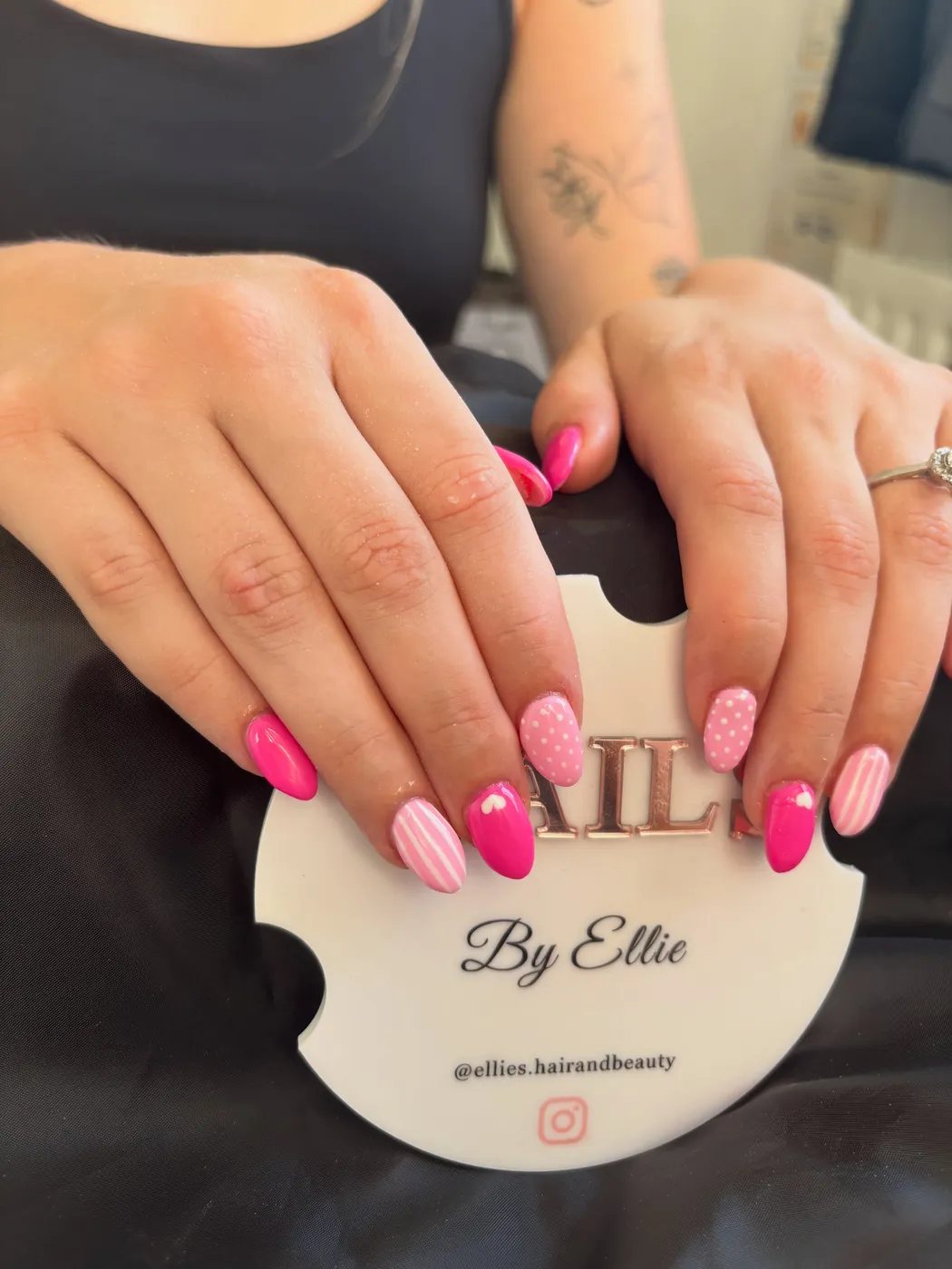 Hot pink and pastel pink nails with heart and stripe nail art